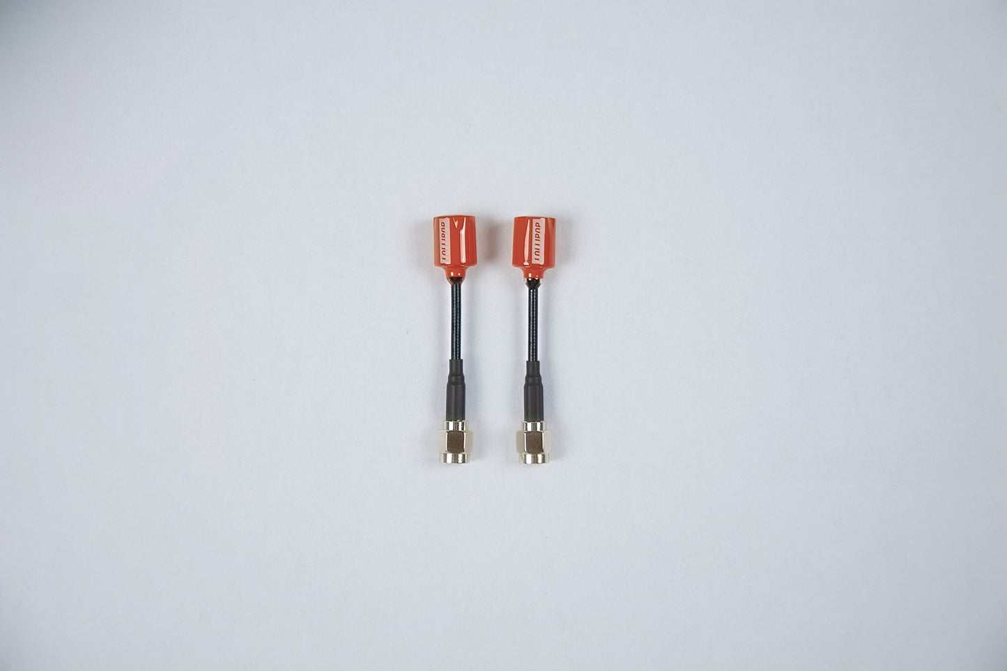 2 red fpv lollipop antennas outside their packaging on a white background