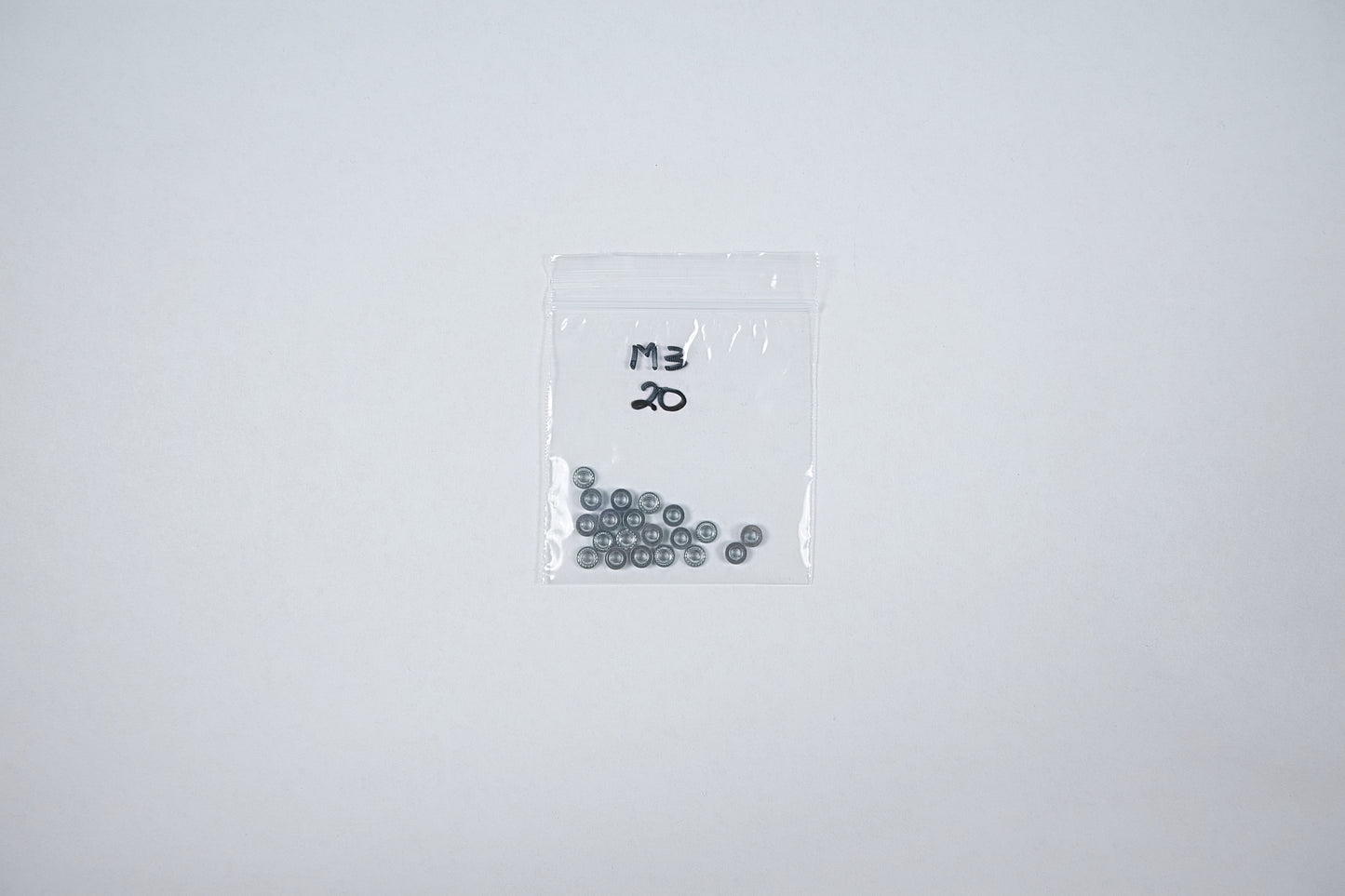 steel m3 press nuts in a bag on a white background
