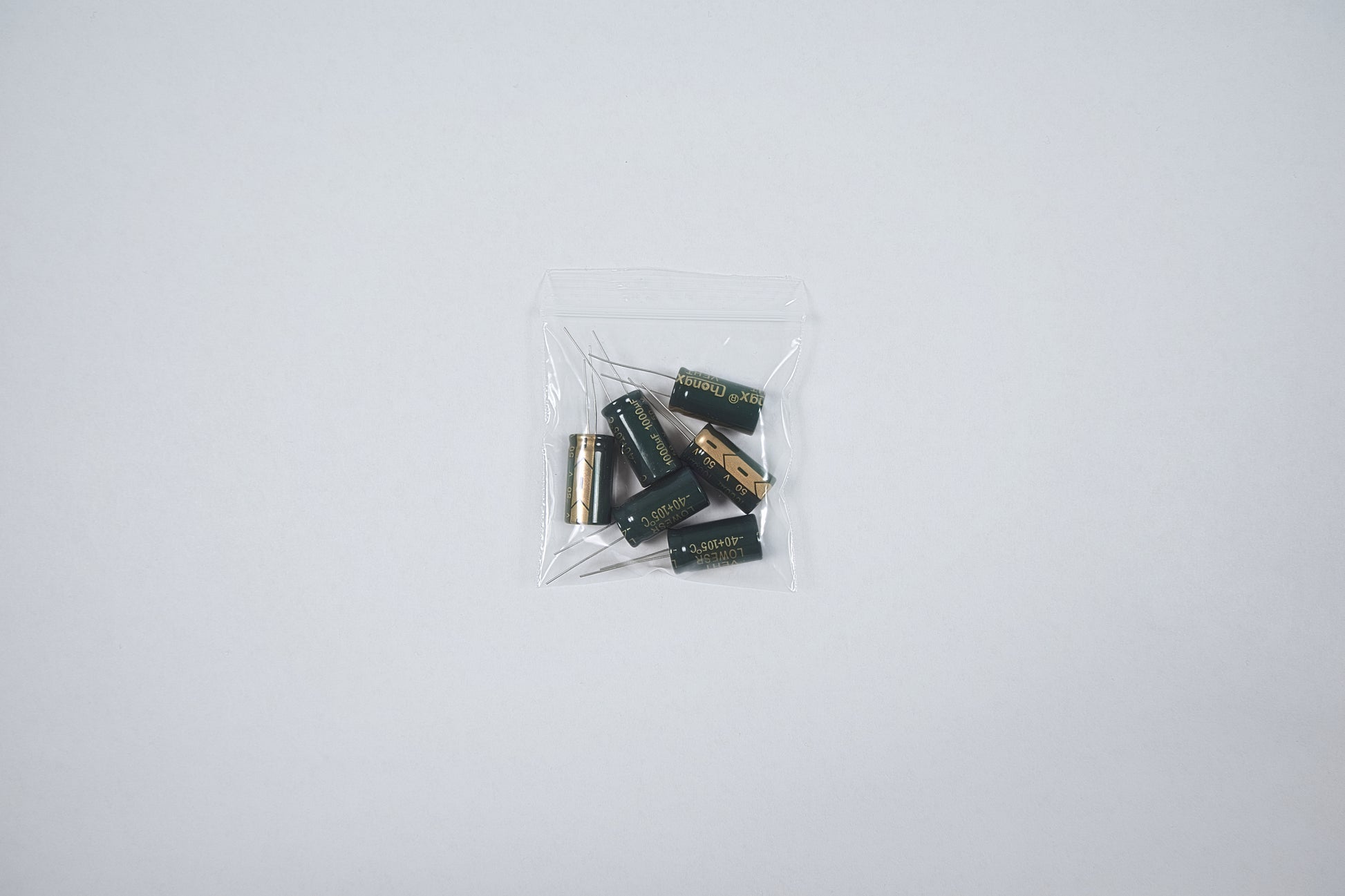 50v 1000uf capacitors in a bag on a  white background