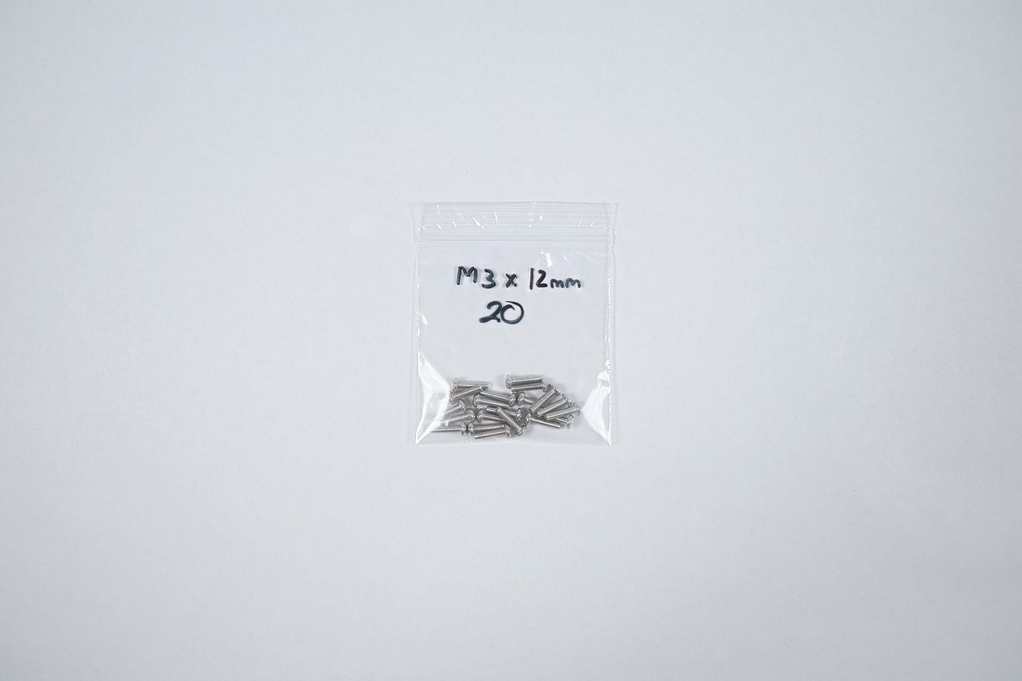 aluminum screws in a bag on a white background
