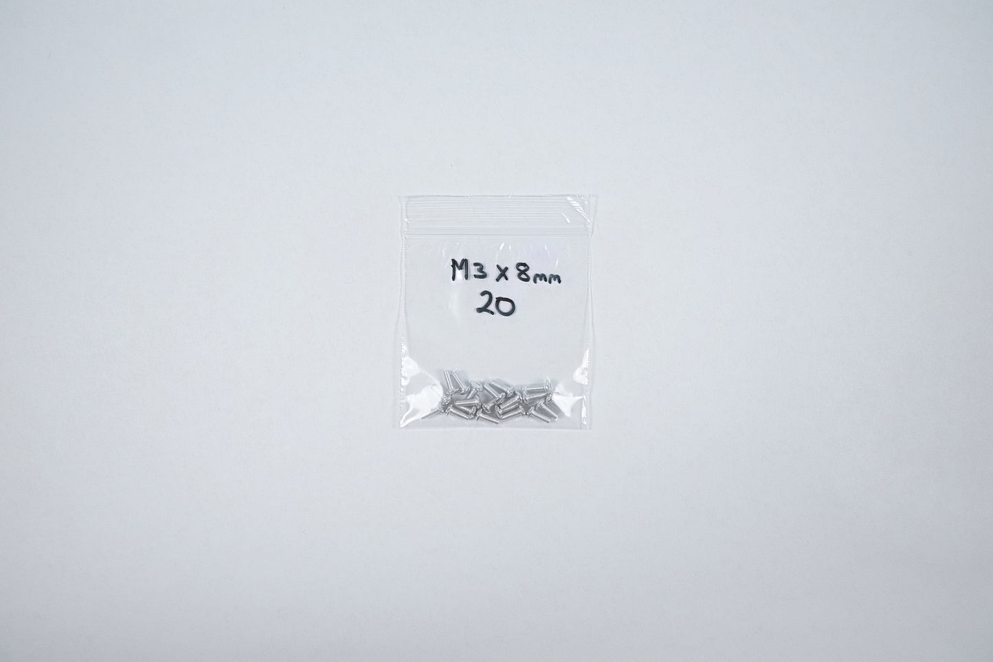 aluminum screws in a bag on a white background