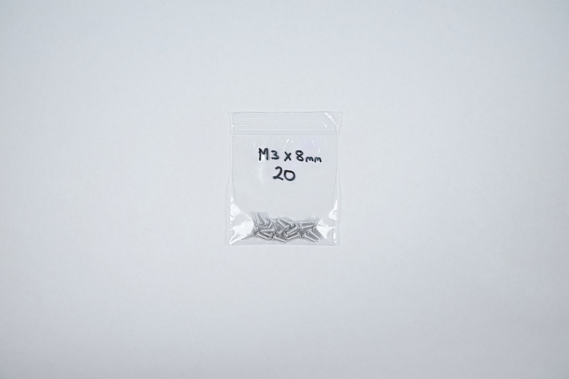 aluminum screws in a bag on a white background