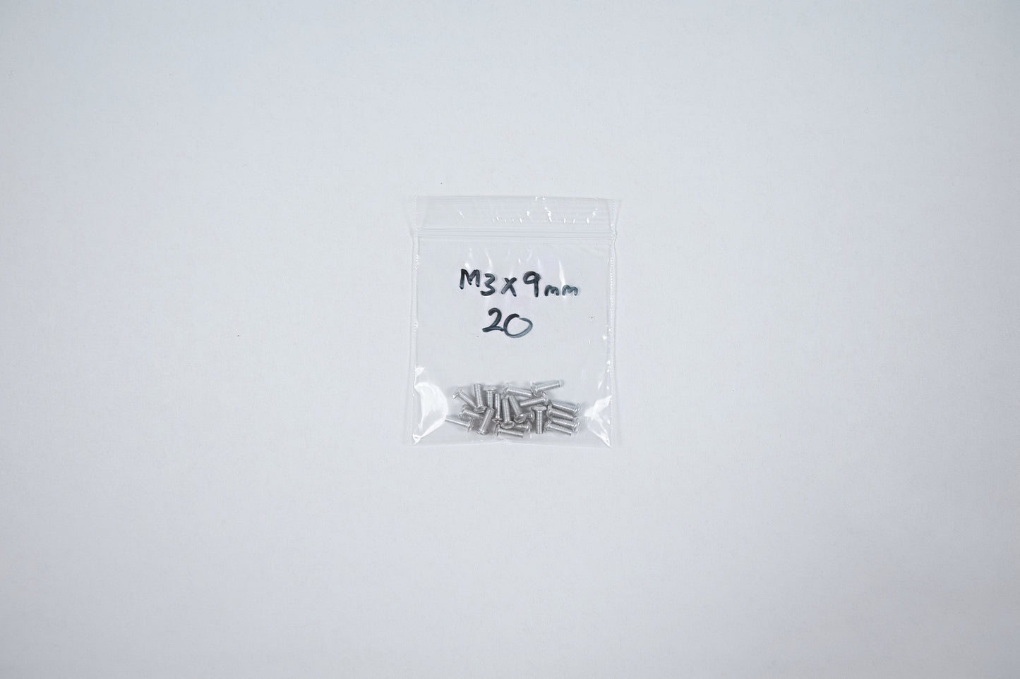 aluminum screws in a bag on a white background
