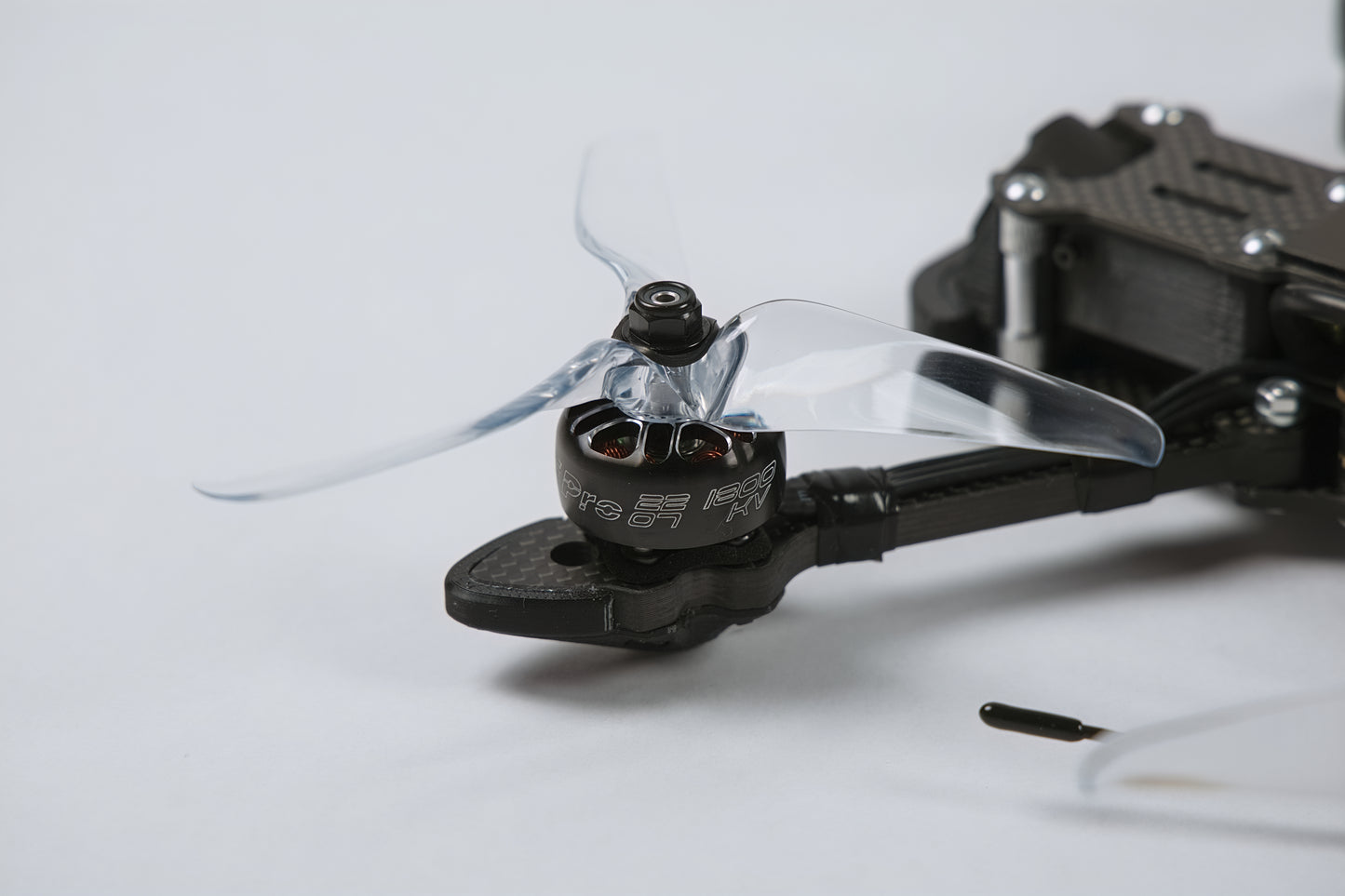 photo of fpv drone, close up of motor and propeller with a white background