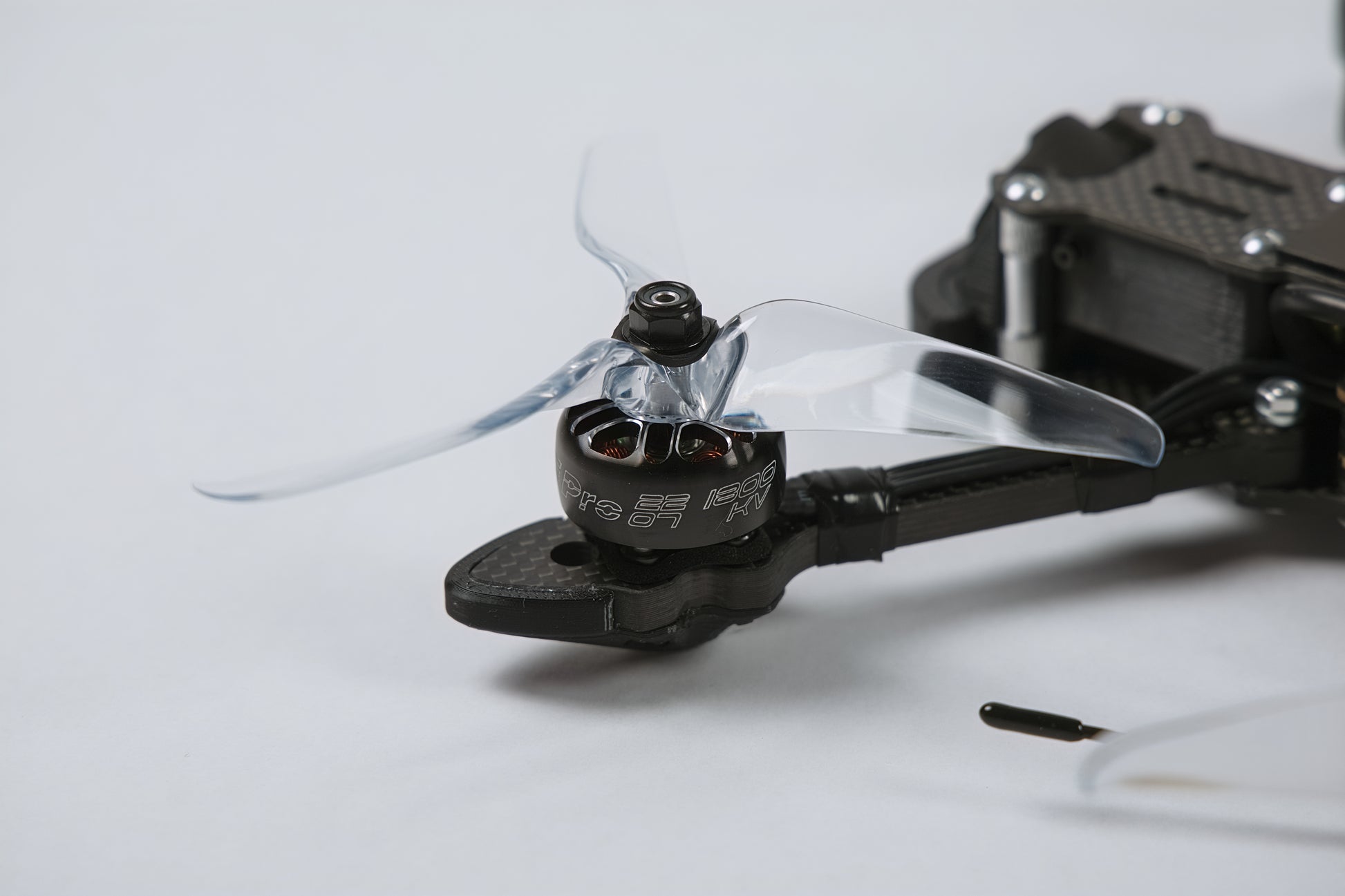 photo of fpv drone, close up of motor and propeller with a white background
