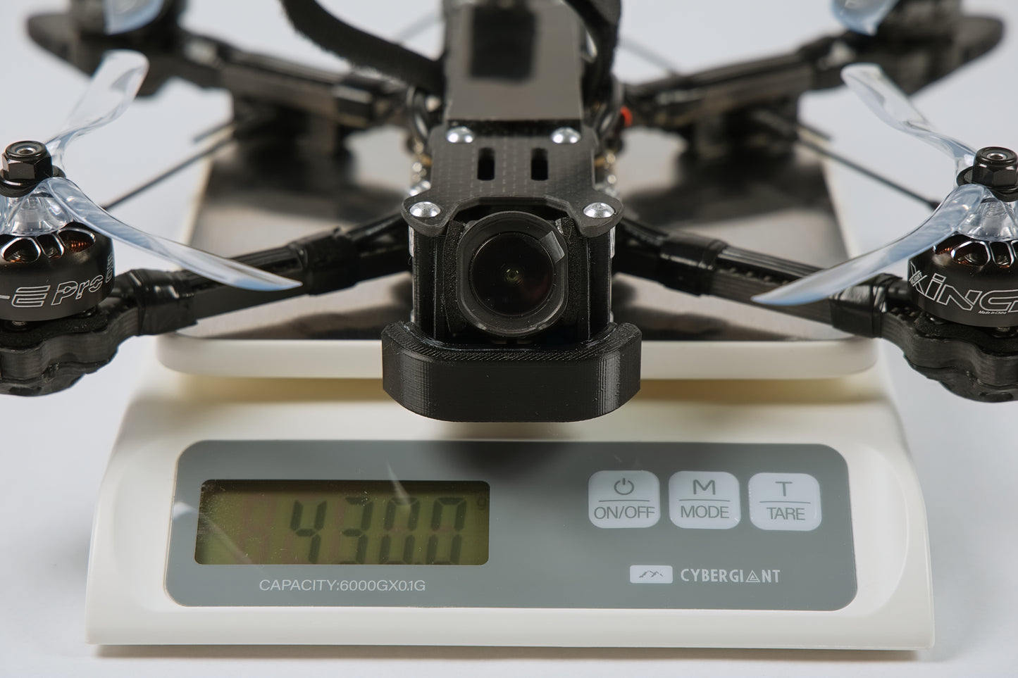photo of fpv drone from the front on a digital scale showing the weight 