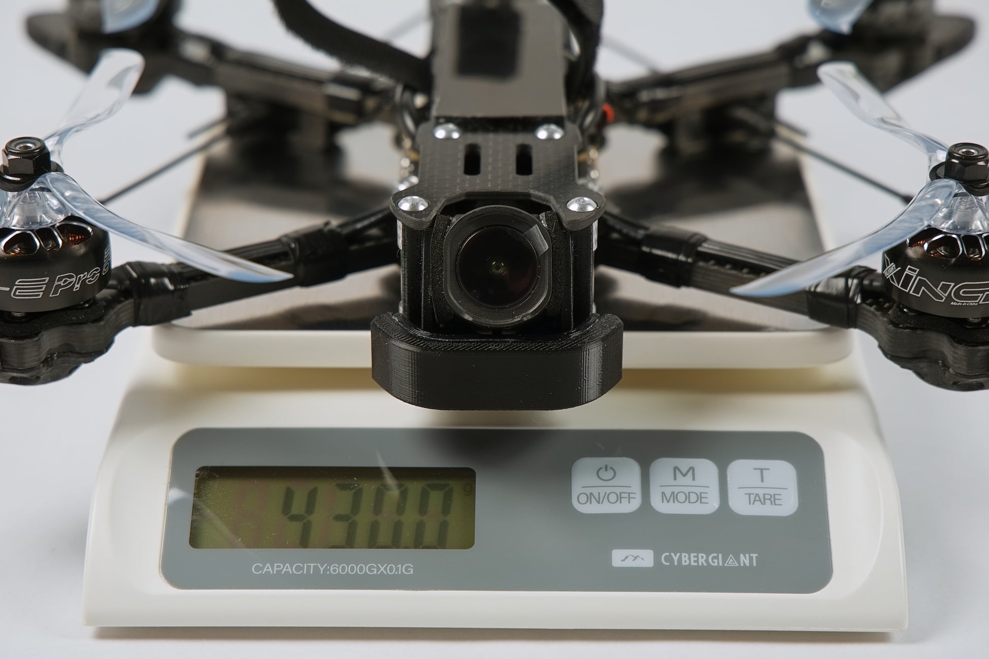 photo of fpv drone from the front on a digital scale showing the weight 