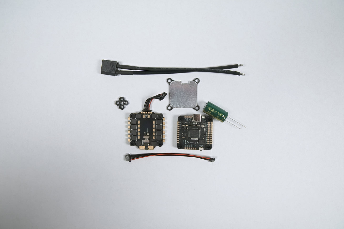 fpv flight stack f722 & (6S) 65amp laid out on a white background