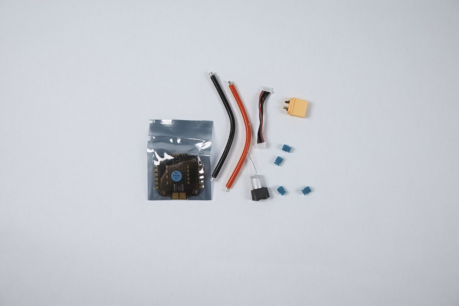 fpv jhemcu esc 65amp unpackaged and seperated on a white background