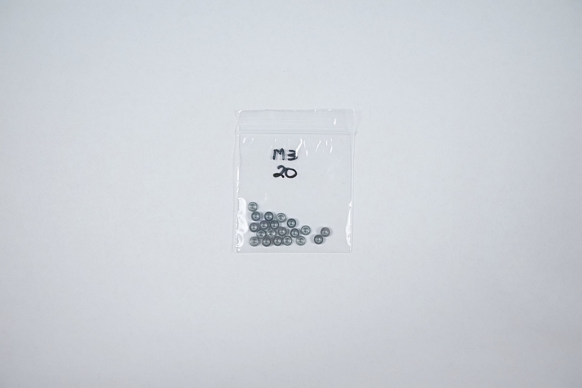 steel m3 press nuts in a bag on a white background 