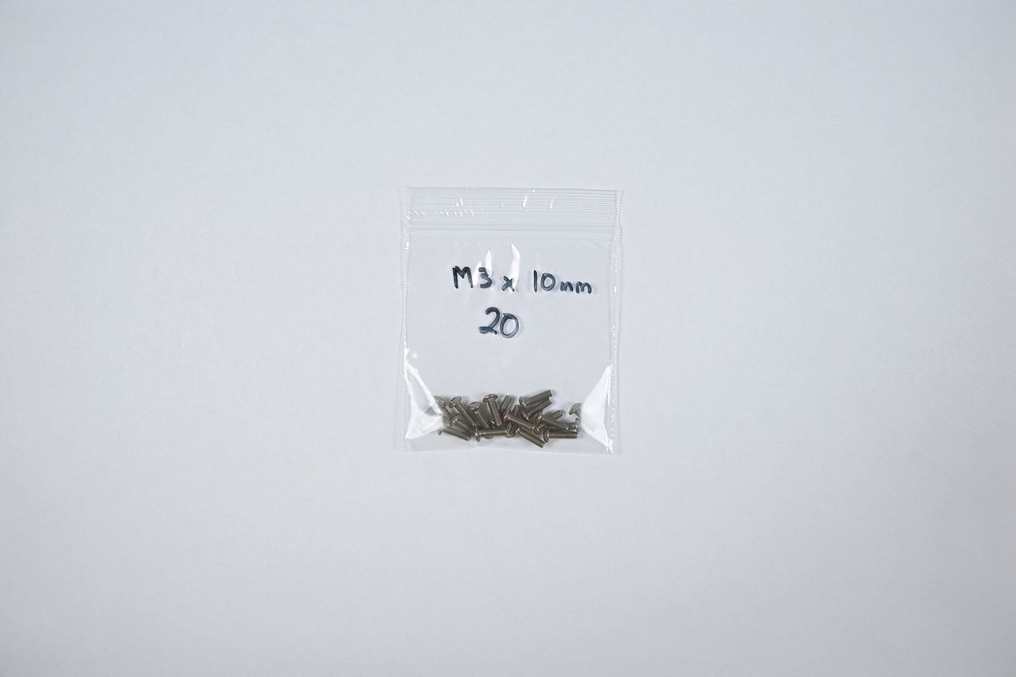 titanium screws in a bag on a white background