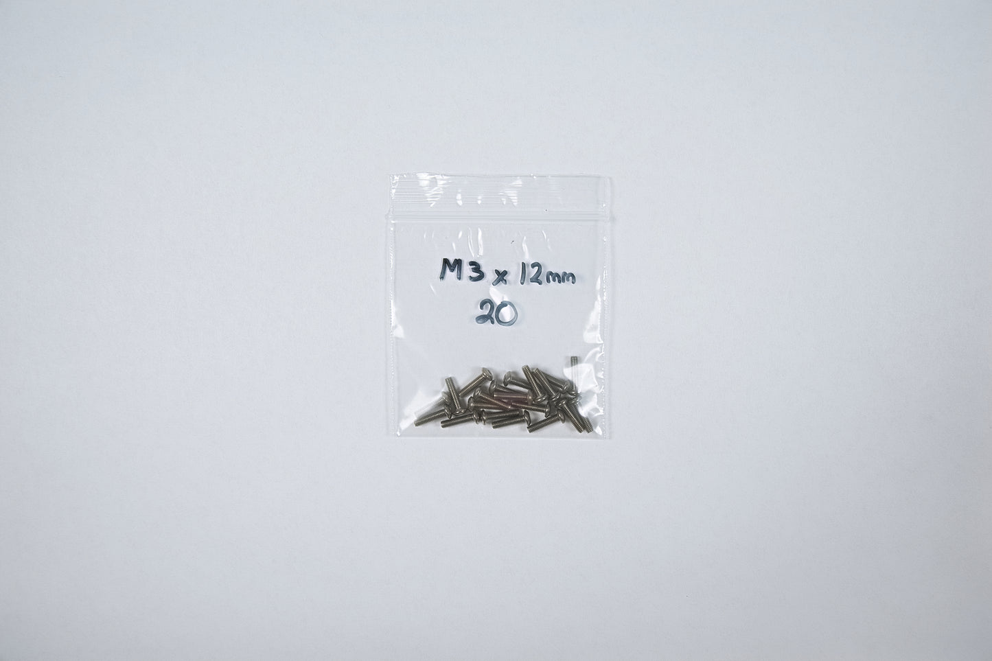 titanium screws in a bag on a white background