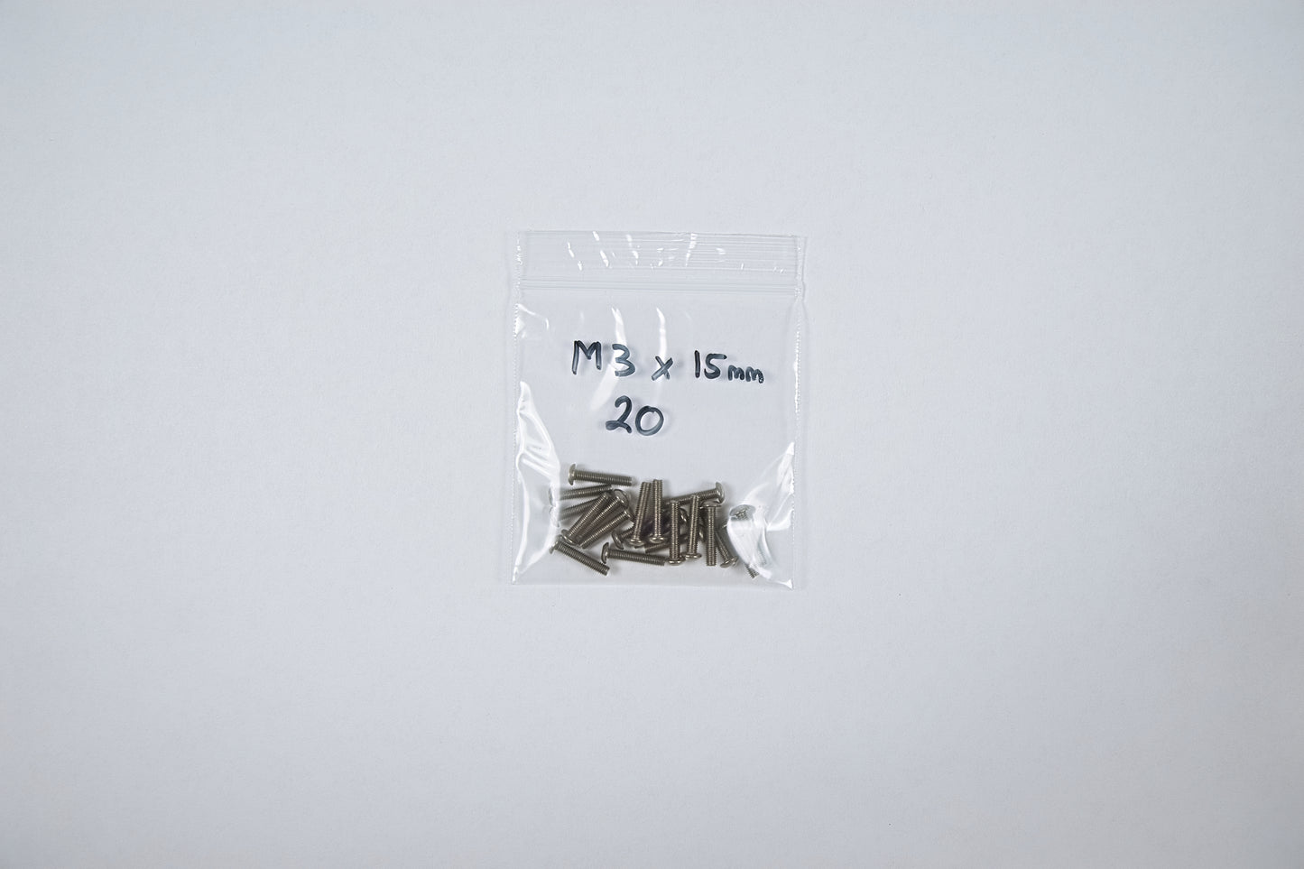titanium screws in a bag on a white background