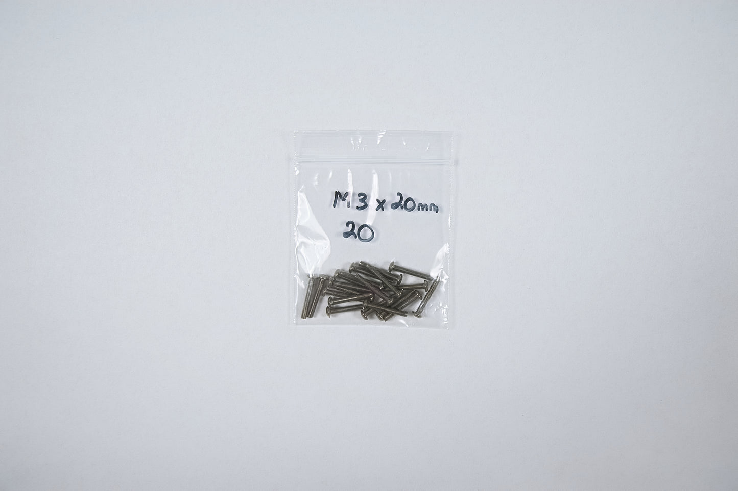 titanium screws in a bag on a white background