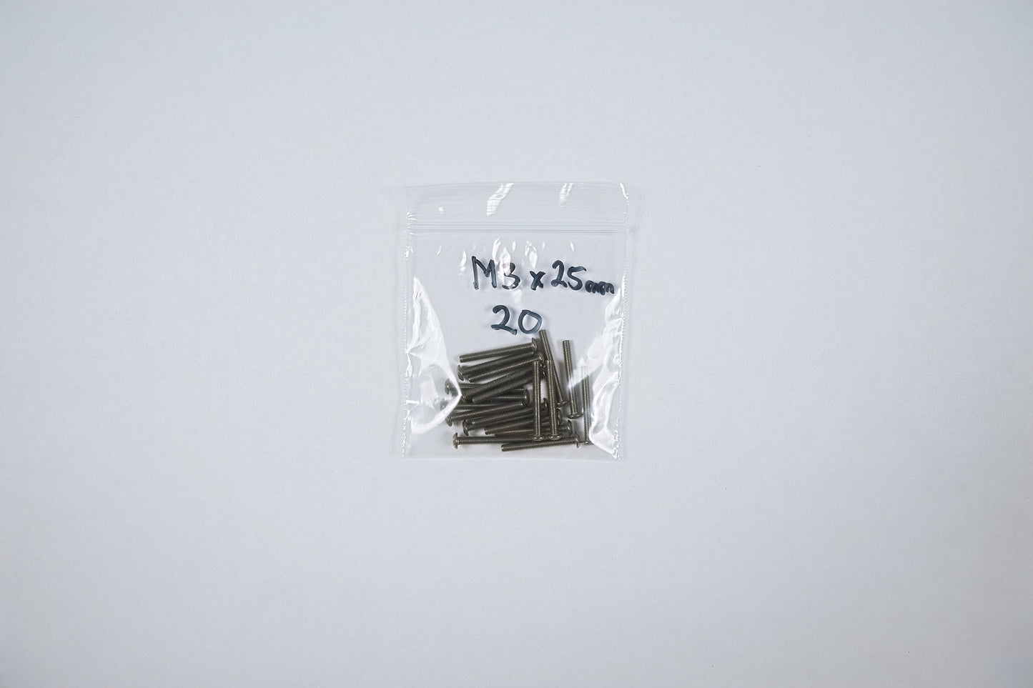 titanium screws in a bag on a white background