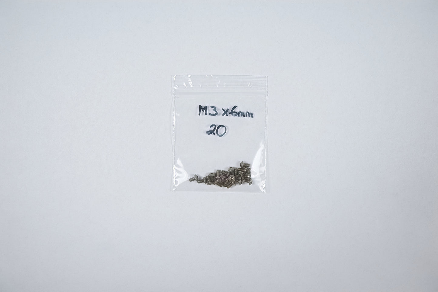 titanium screws in a bag on a white background